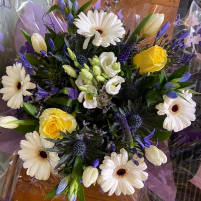 Yellow and White Elegance - A delicate arrangement of yellow and white flowers, perfect for both celebratory and commemorative occasions.