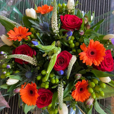 Red and Orange Celebration - A vibrant mix of red and orange flowers, ideal for celebrations and making a bold statement.