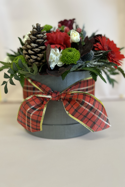 Christmas Collection - A beautiful arrangement in oasis. A perfect centre piece for any table. A stunning mixture of reds, greens and a little bit of snow for that Christmas feel. All finished with a Chr