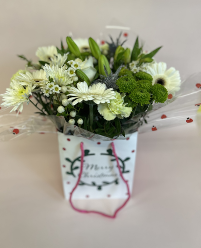 Frosty Morning - A twist on the classic, this white giftbag gives a modern feel. A mix of white, snow and glitter, it’s sure to be favourite.

Includes – White germinis, white rose, thistle, white lily, berries, alstromeria, feeling green, delianne, green carnations, waxflower and greenery