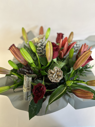 Christmas Collection - For those that want something a little different. A beautiful mixture of red lilies and roses with some greenery. Simple yet stunning.